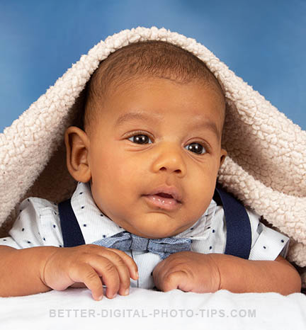 Baby under blanket pose