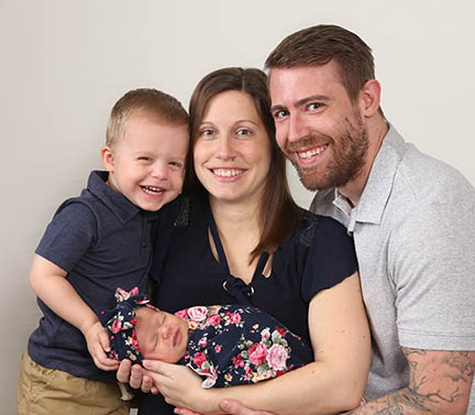 family pose with newborn