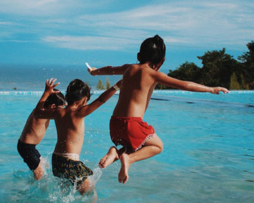 kids jumping in swimming pool