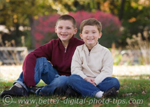 Outdoor portrait of two boys in the shade with fill light bounced from a white reflector board.