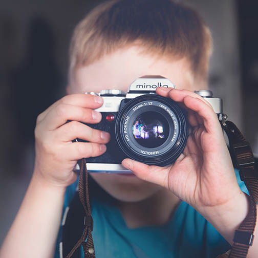 young boy with camera